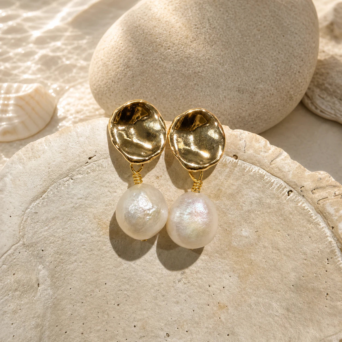 Petite baroque pearl drop earrings in gold styled with shell detail