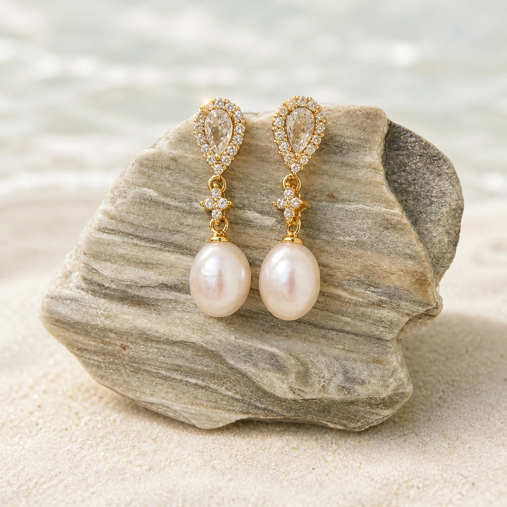 Crystal pearl teardrop earrings in gold close-up with teardrop crystal detail