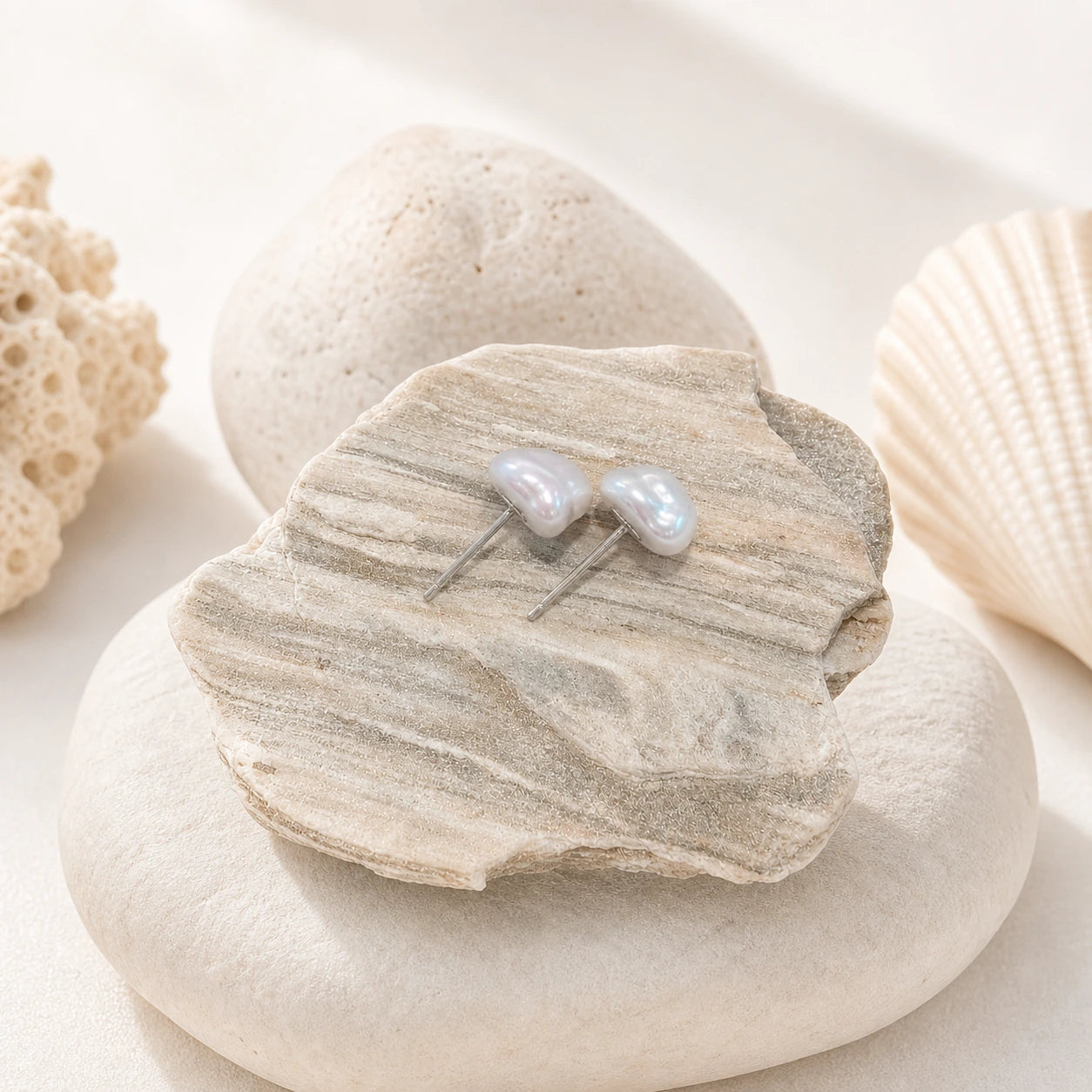 Blue baroque pearl stud earrings in silver close-up with silver posts.