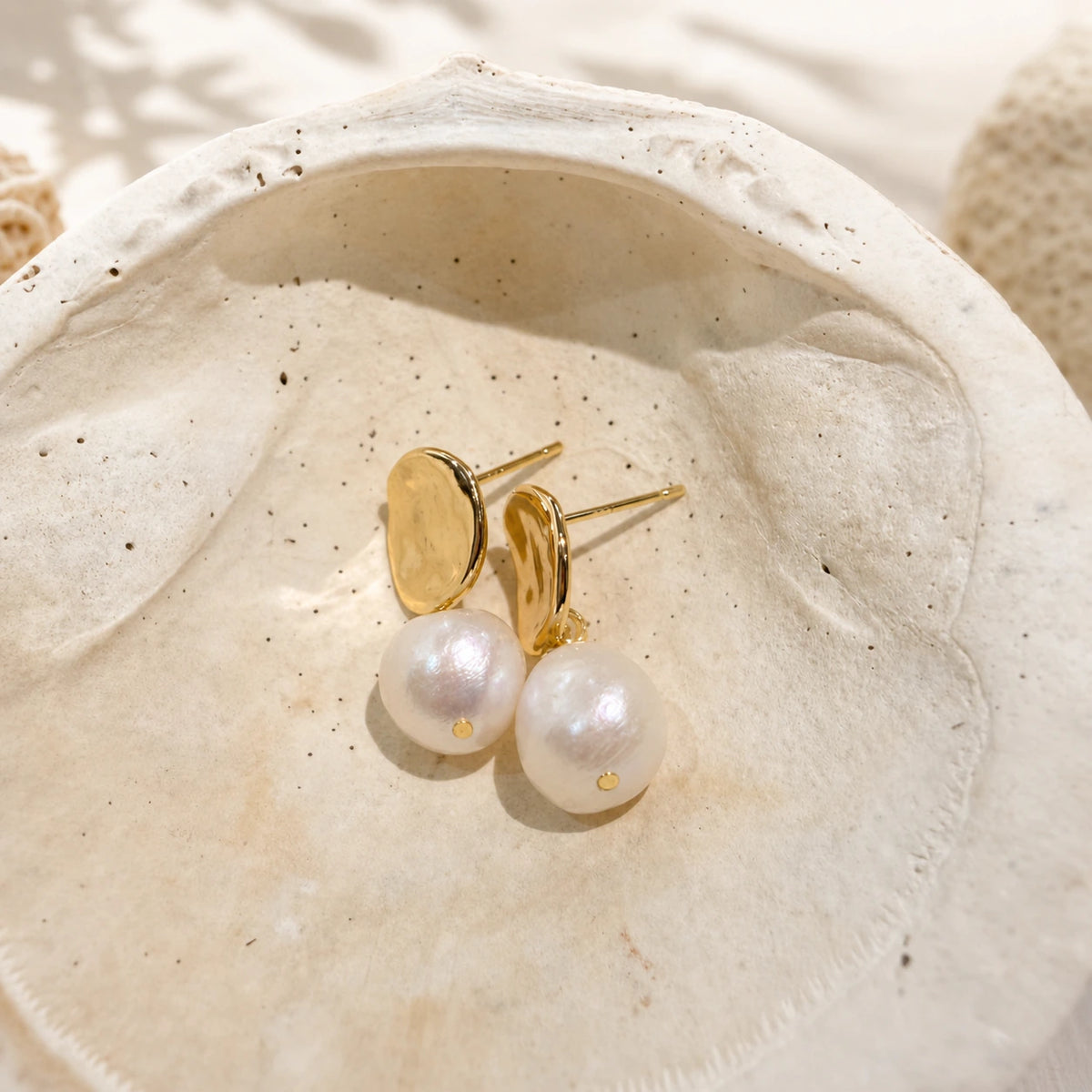 Petite baroque pearl drop earrings in gold close-up with baroque pearl detail