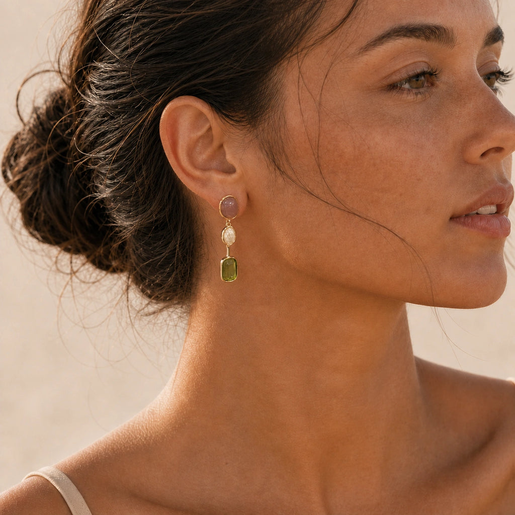Green crystal drop earrings in gold model wearing close-up