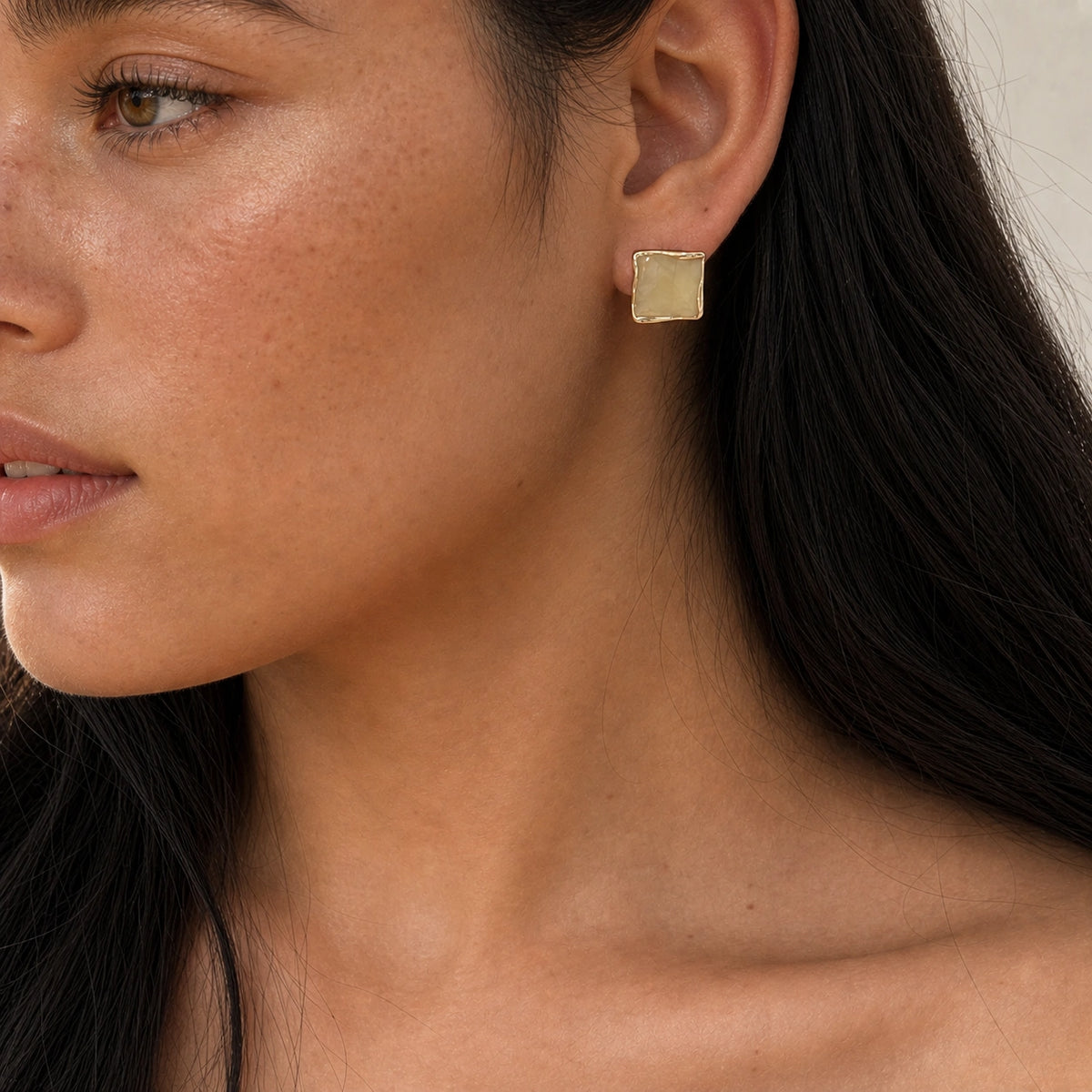 Butter yellow square stud earrings in gold model wearing close-up