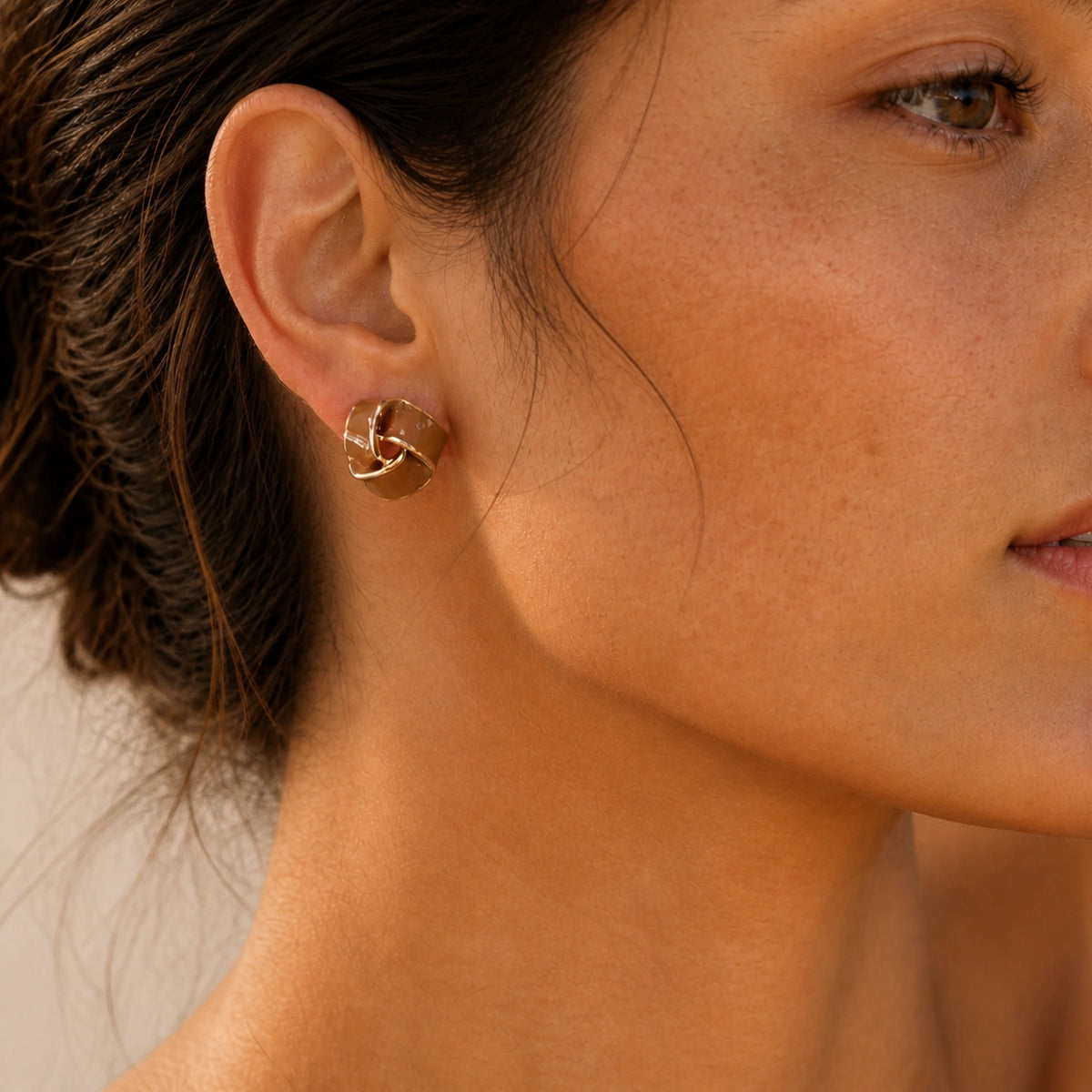 Brown geometric stud earrings model wearing close-up