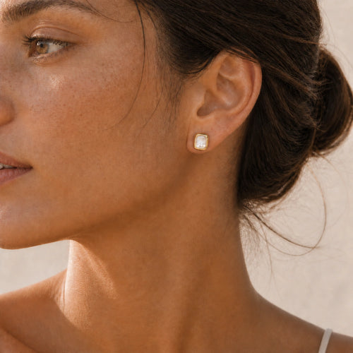 Mother-of-pearl stud earrings in gold model wearing close-up