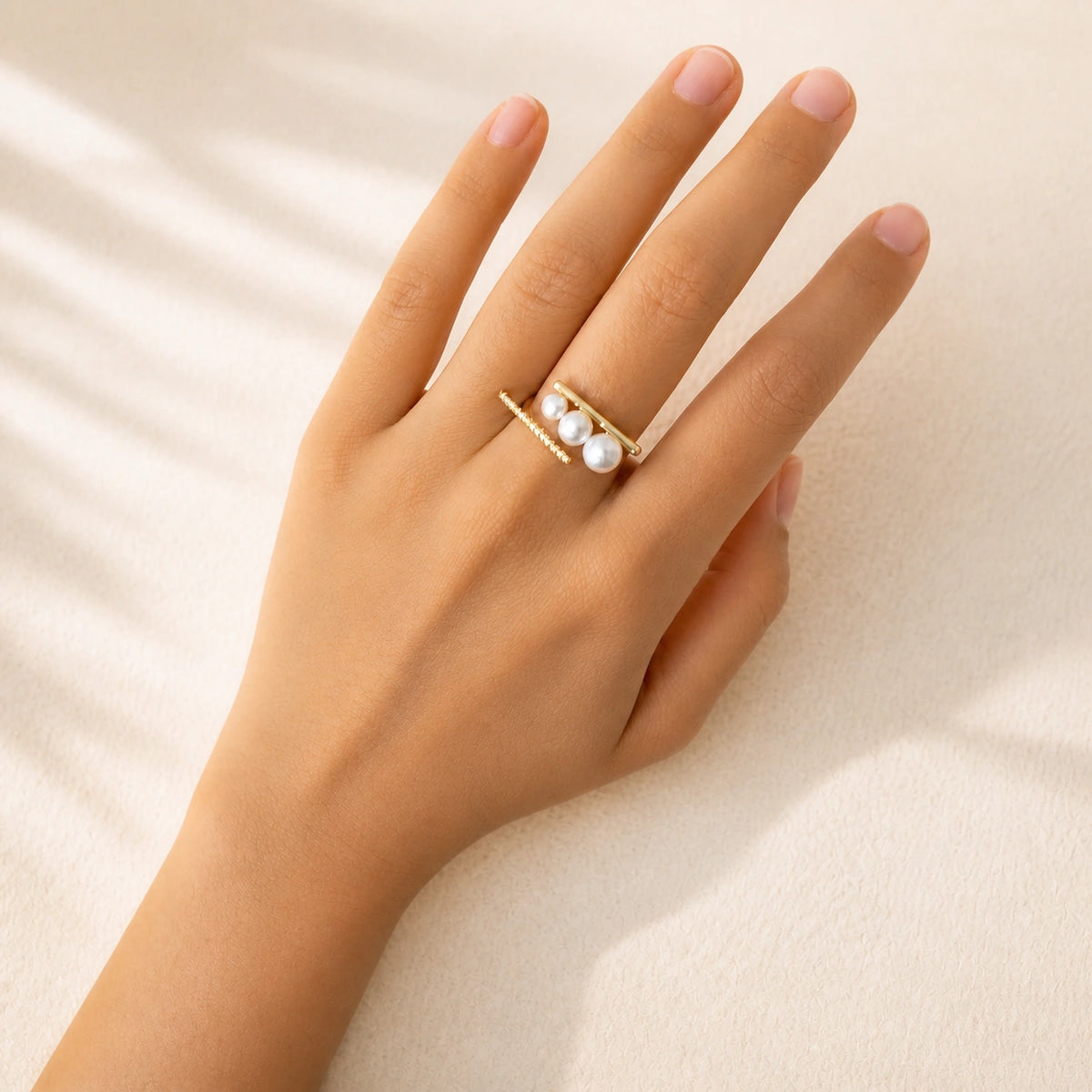 French triple pearl ring in gold model wearing on hand