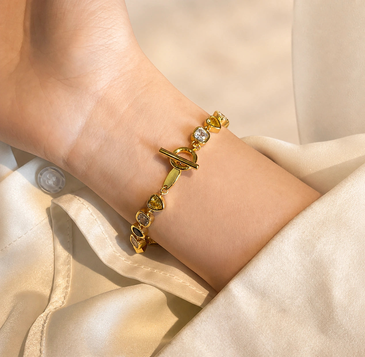 Gold coloured cubic zirconia bracelet worn close-up
