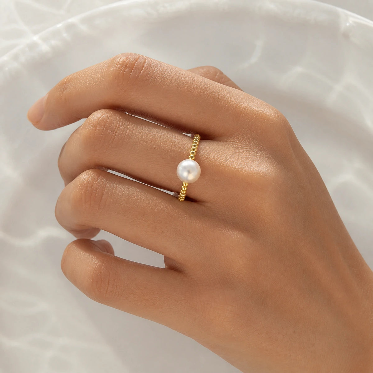 Minimal pearl ring in gold model wearing close-up