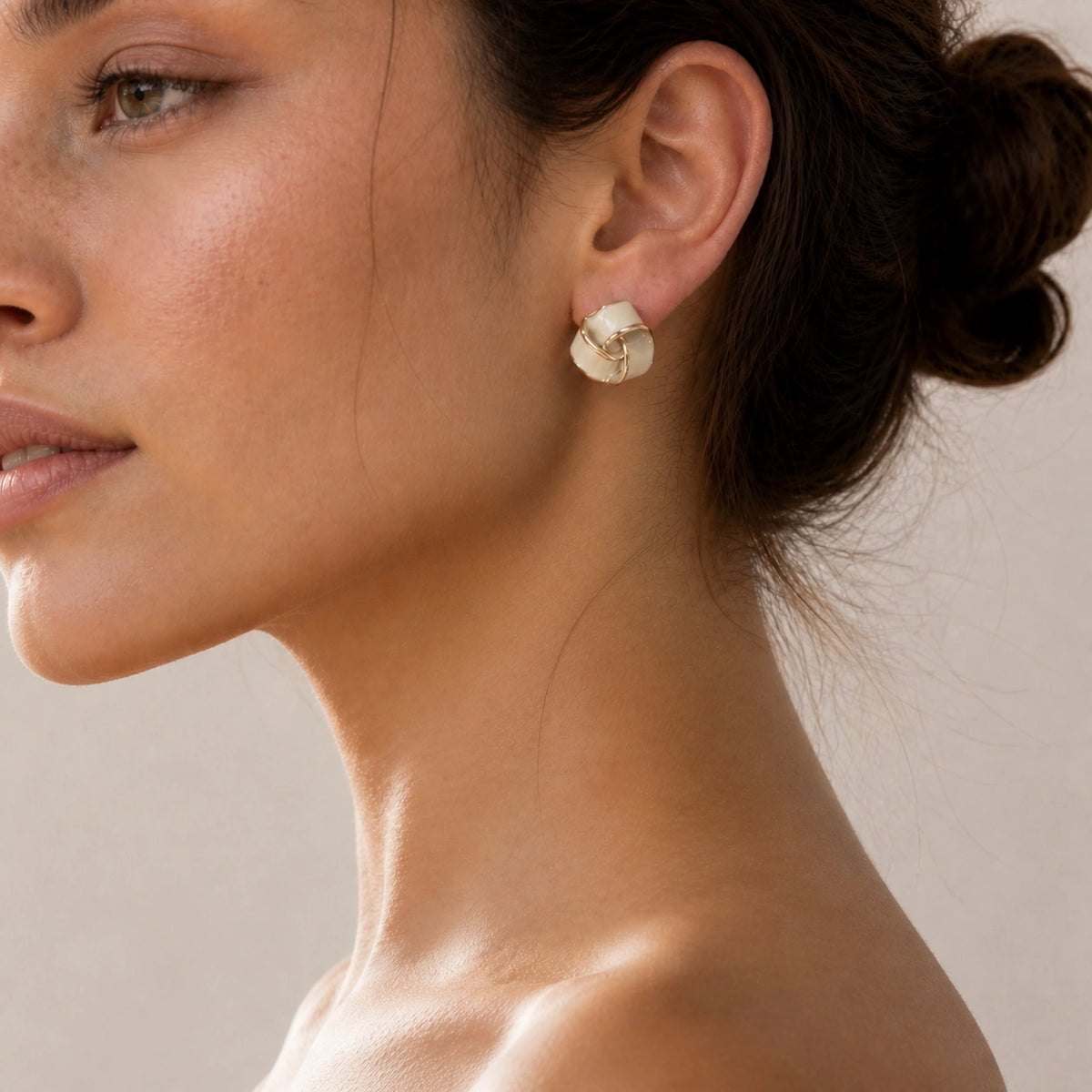 Cream geometric stud earrings model wearing close-up