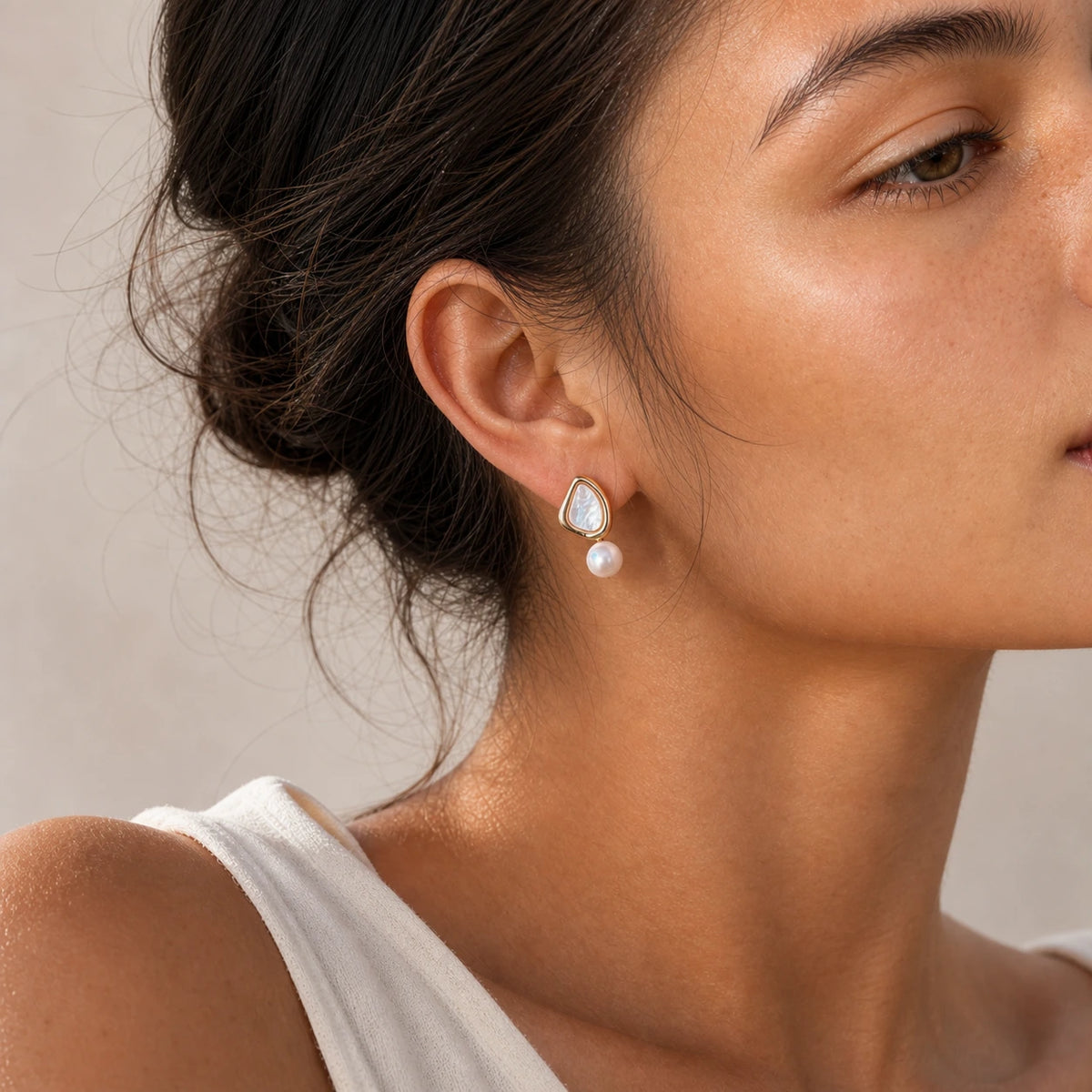 Triangle pearl stud earrings model wearing close-up