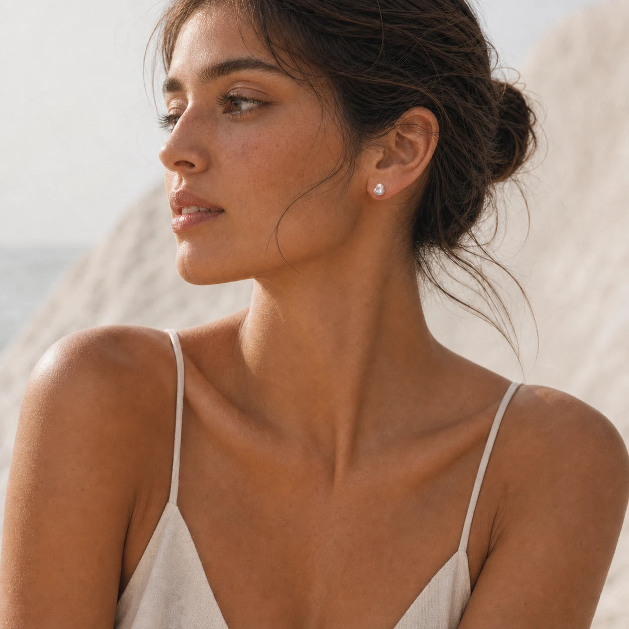 Blue baroque pearl stud earrings in silver model wearing shoulder view.