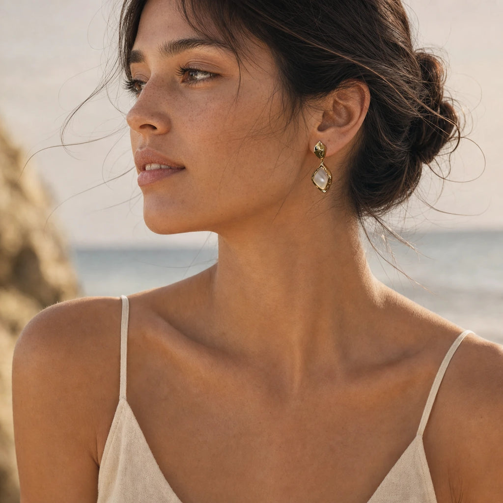 Square mother-of-pearl drop earrings in gold model wearing shoulder view
