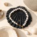 Baroque freshwater pearl bracelet with gold extension chain styled on a black shell