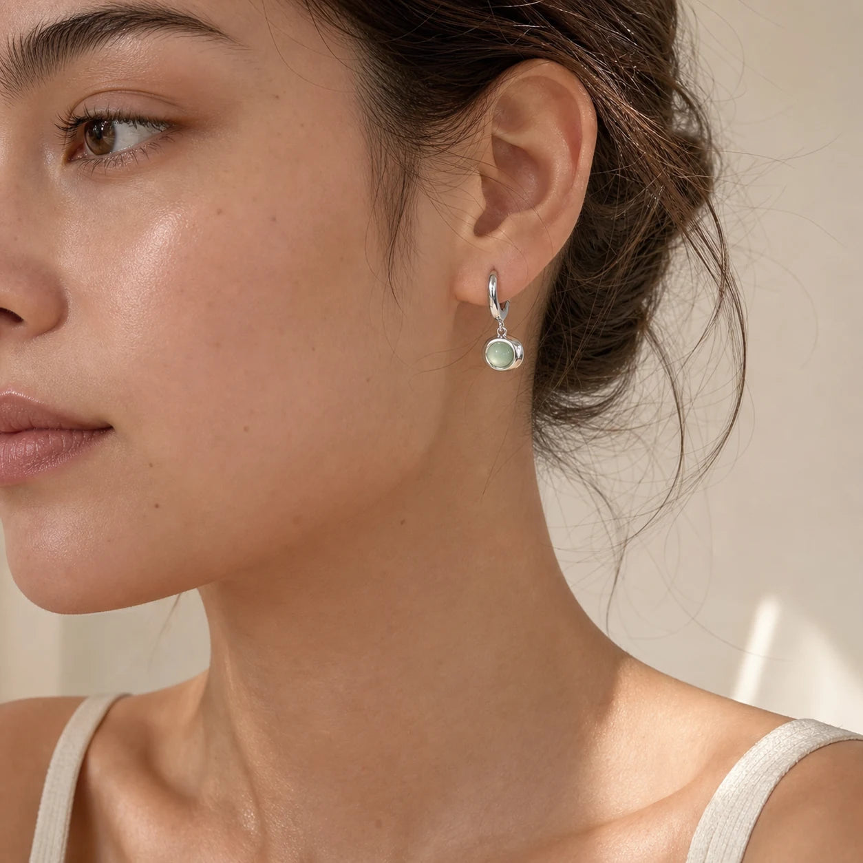 Close-up of cat's eye drop earrings in Gold-plated brass with 925 sterling silver hooks.