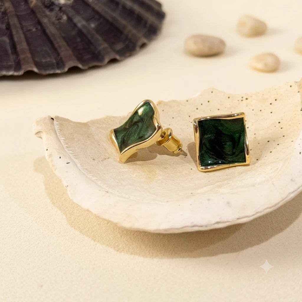 Close-up of dark green square earrings in Gold-plated brass with 925 sterling silver posts.