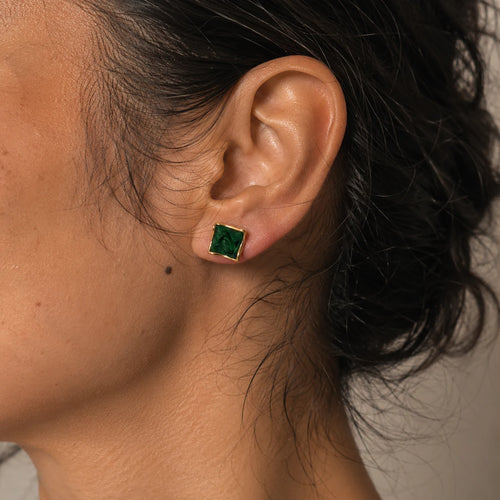 Close-up of dark green square earrings in Gold-plated brass with 925 sterling silver posts.