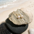 Freshwater Pearl Earrings 7-8mm in 925 sterling silver displayed in a product styling scene.