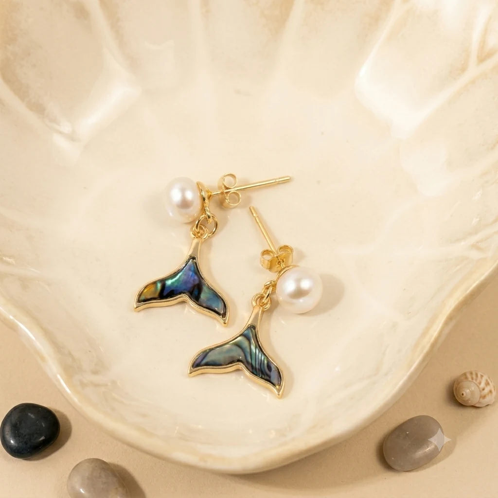 Close-up of freshwater pearl earrings in Gold-plated brass with 925 sterling silver posts.