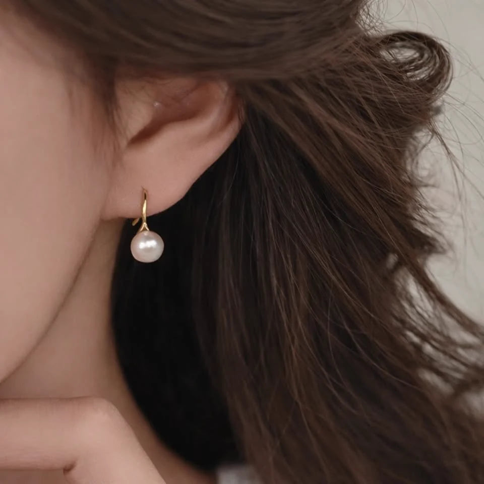 Close-up of freshwater pearl hook earrings 8mm in Gold-plated 925 sterling silver.