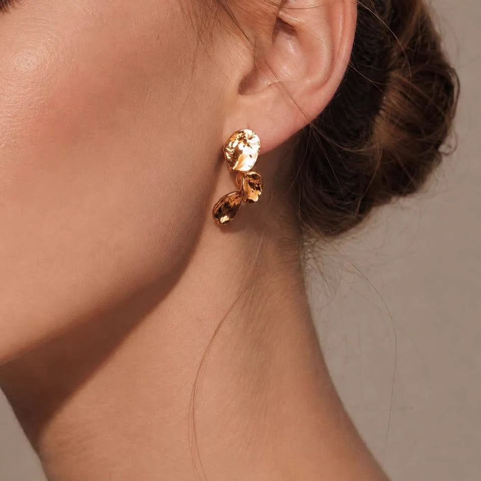 Leaf Earrings in Gold-plated brass with 925 sterling silver hooks displayed in a product styling scene.