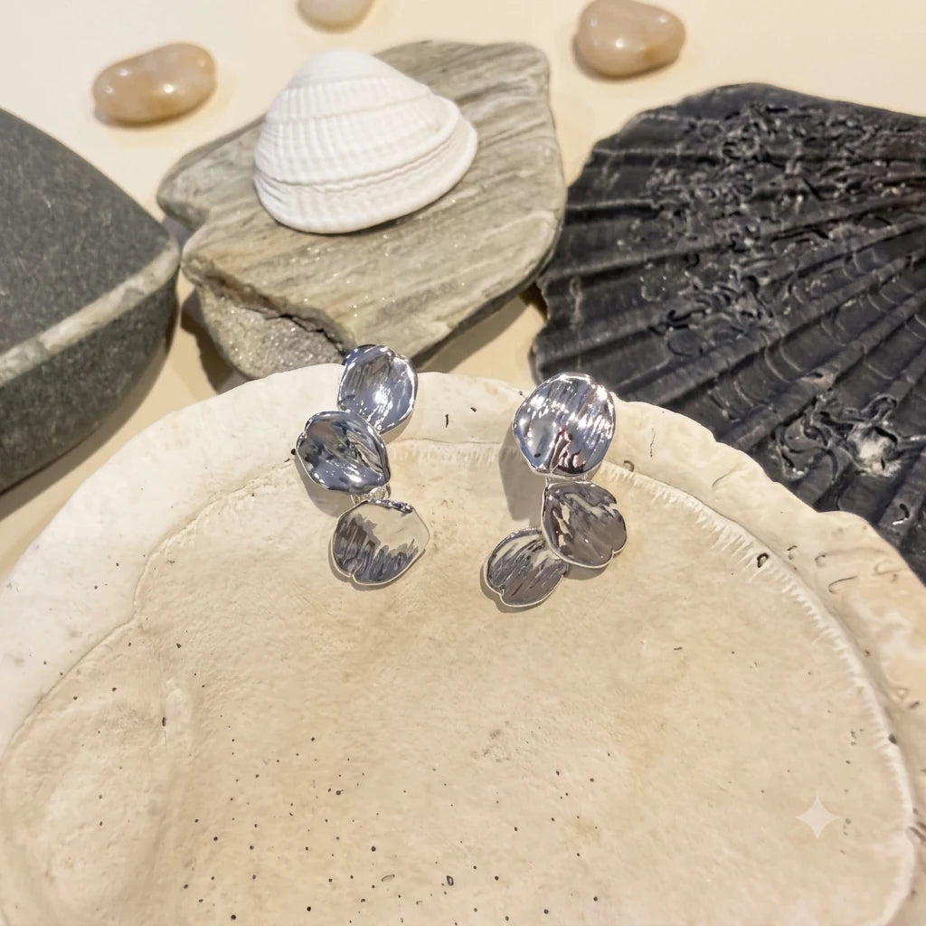 Leaf Earrings in Rhodium-plated brass with 925 sterling silver posts displayed in a product styling scene.