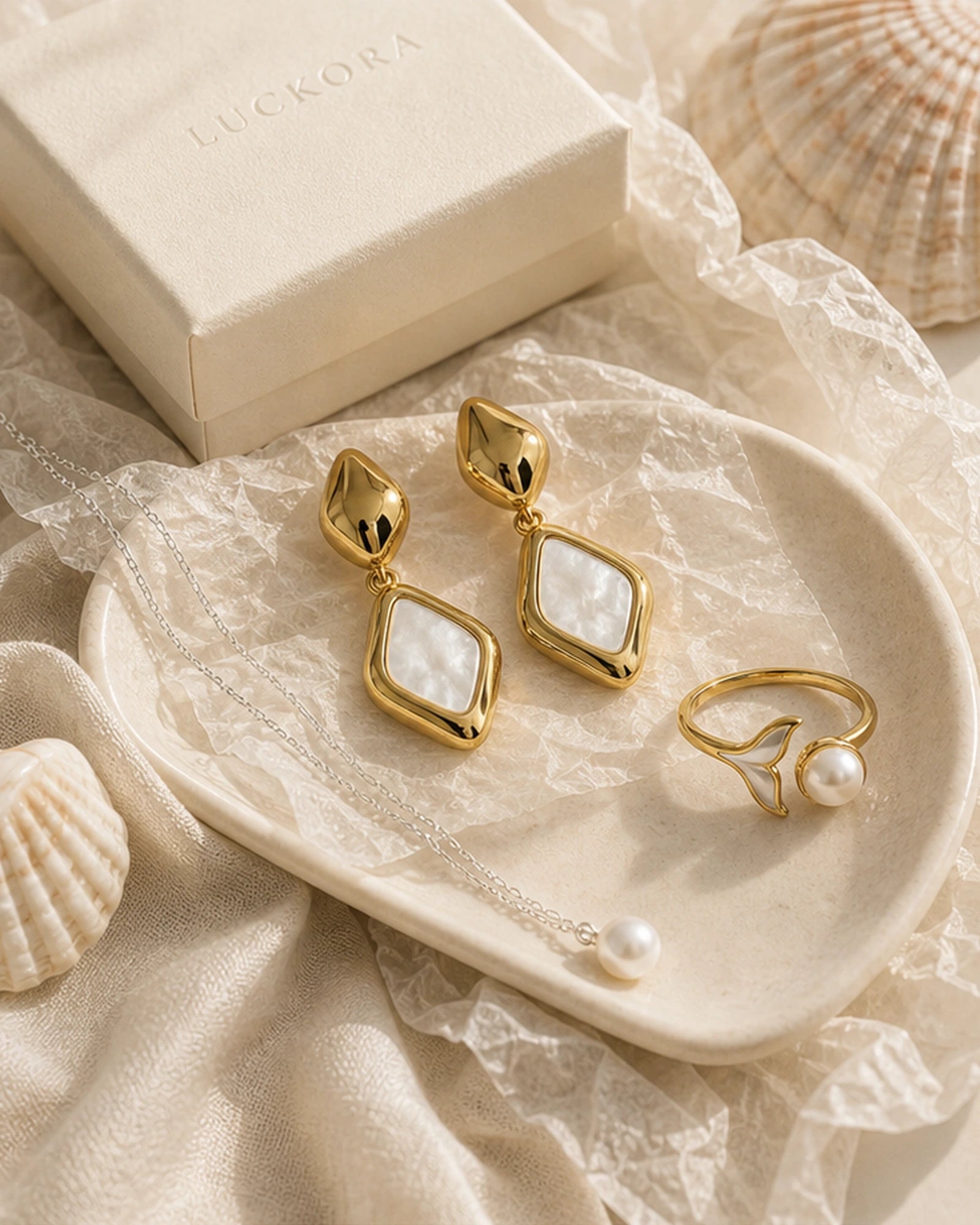 Luckora pearl jewellery still life with mother-of-pearl earrings, pearl necklace and ring styled with gift box and shells