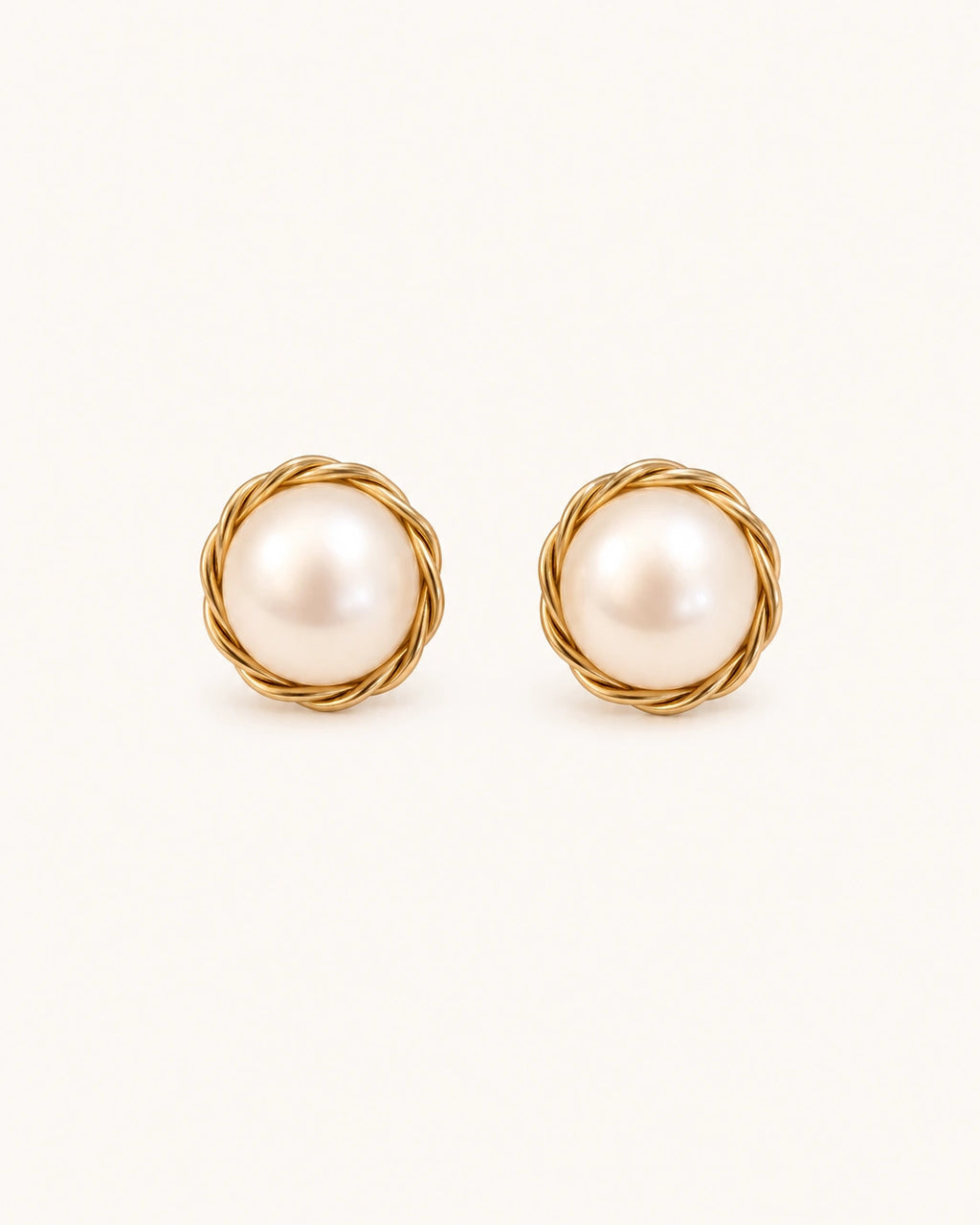 Wrapped pearl stud earrings in gold white background main image