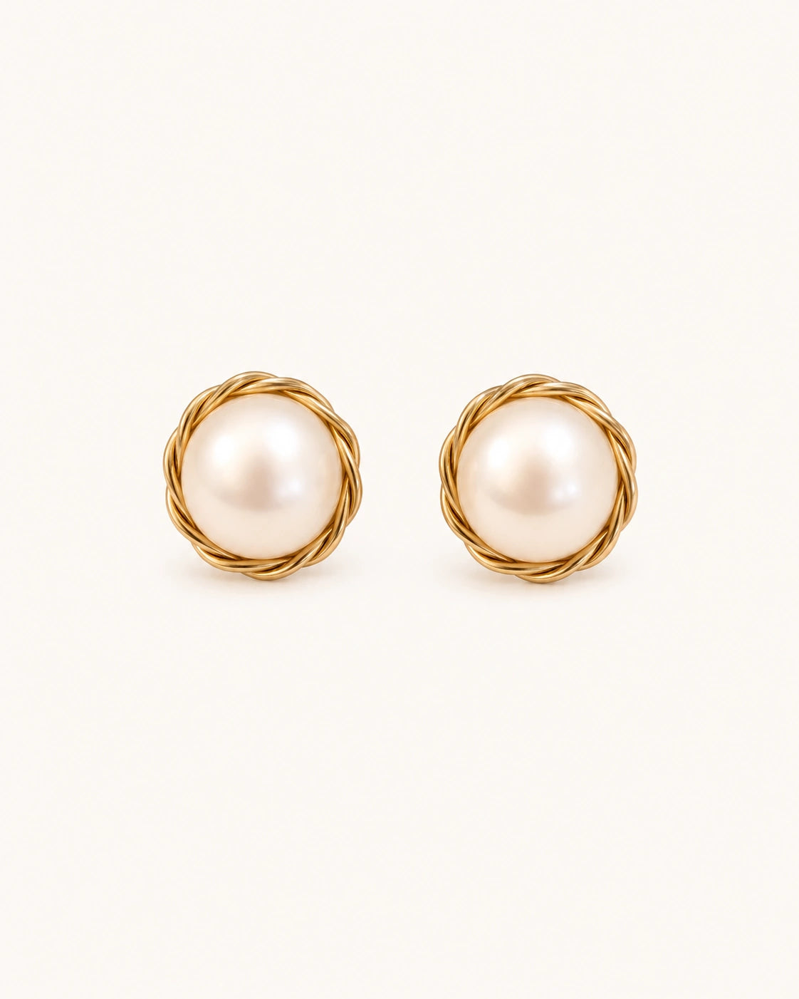 Wrapped pearl stud earrings in gold white background main image