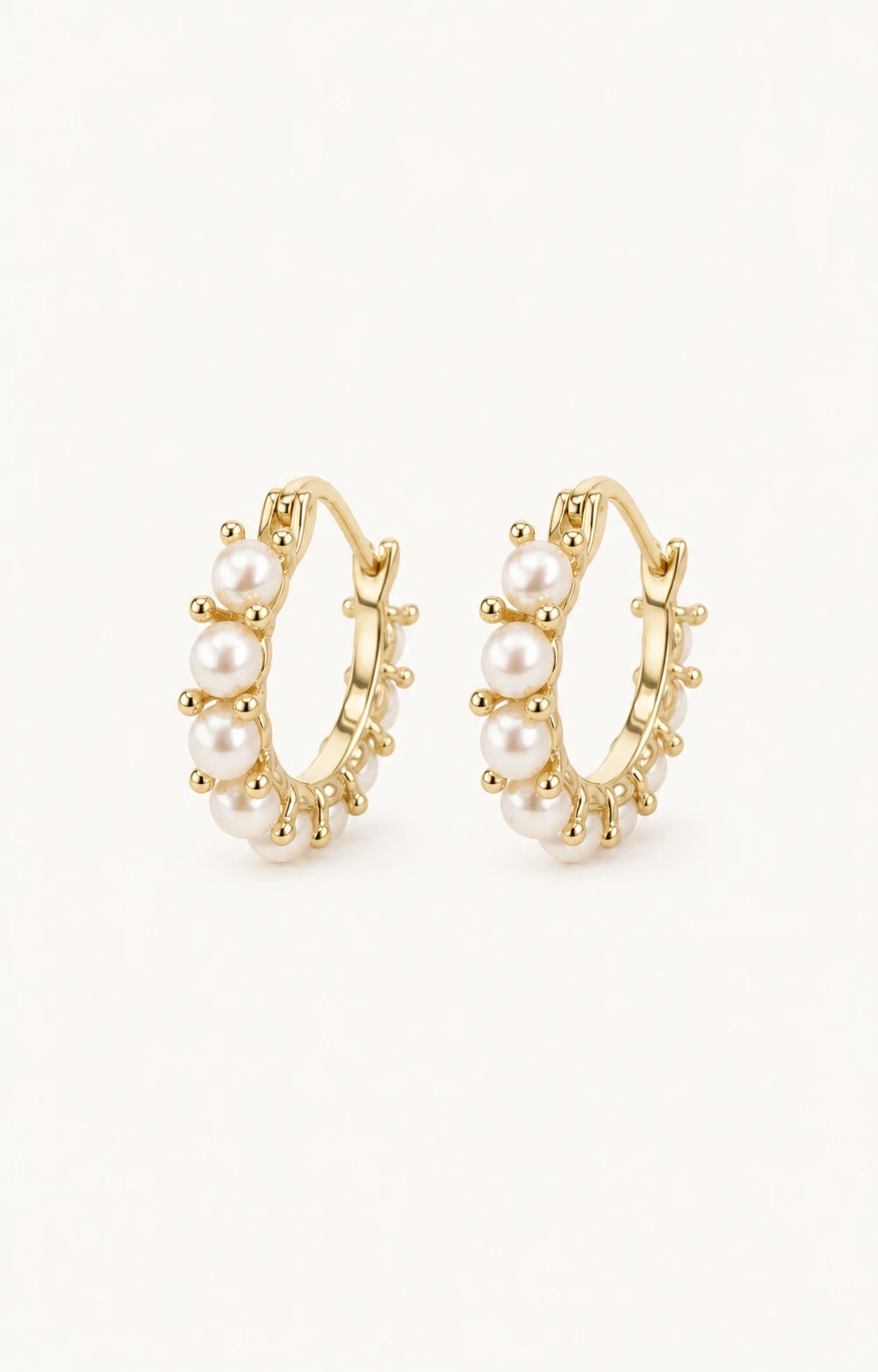 Mini pearl huggie earrings white background main image