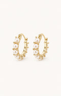 Mini pearl huggie earrings white background main image