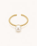 Minimal pearl ring in gold on clean white background