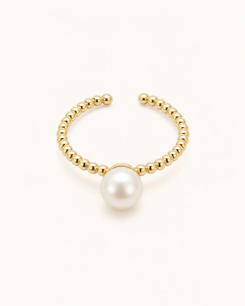 Minimal pearl ring in gold on clean white background