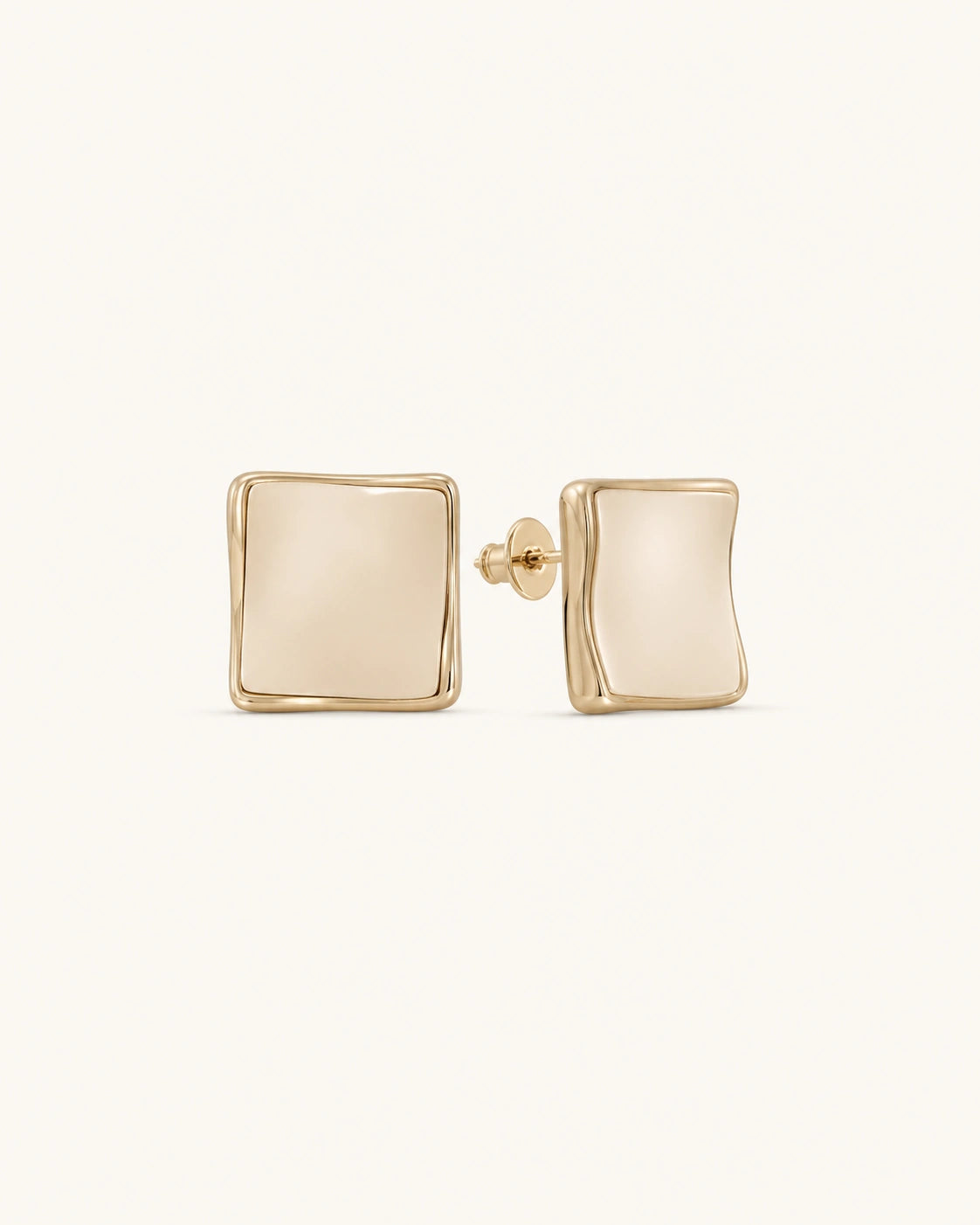 Cream square stud earrings in gold on clean white background