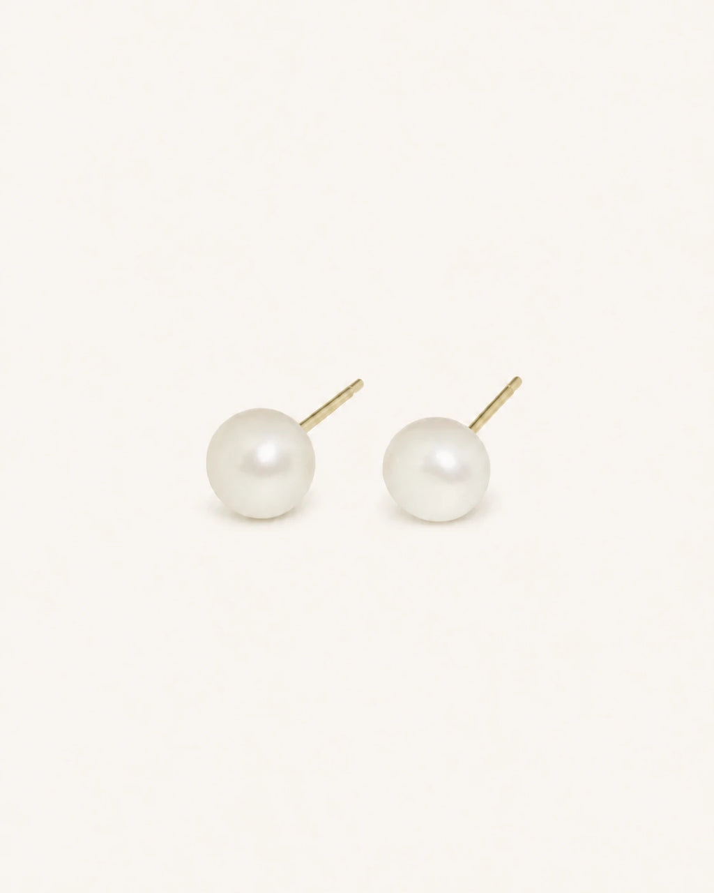Classic white pearl stud earrings in gold white background product image