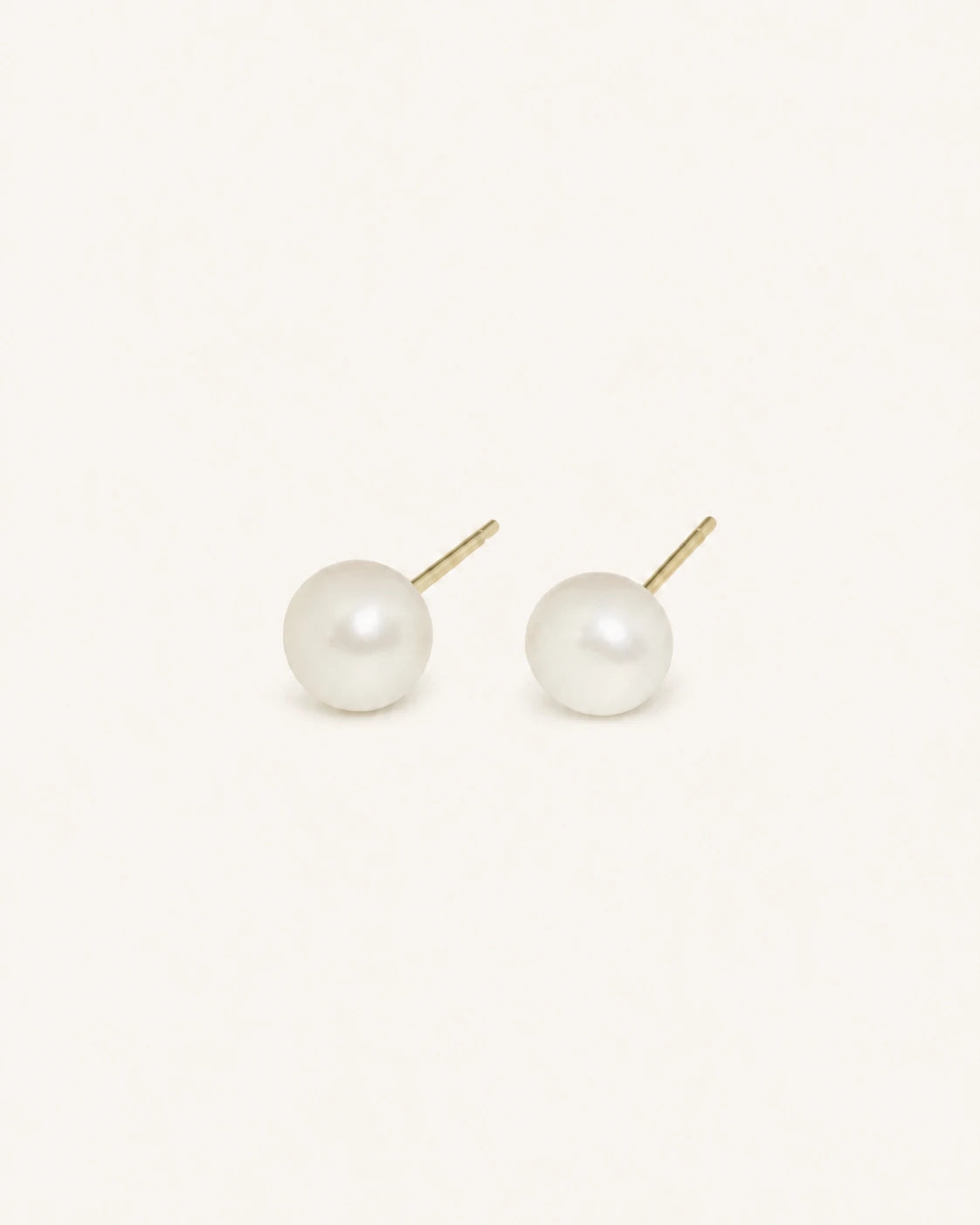 Classic white pearl stud earrings in gold white background product image