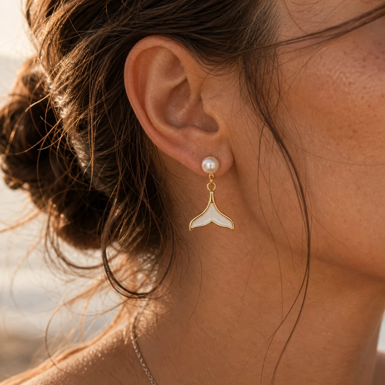 Close-up of mermaid pearl drop earrings in Gold-plated brass with 925 sterling silver posts.