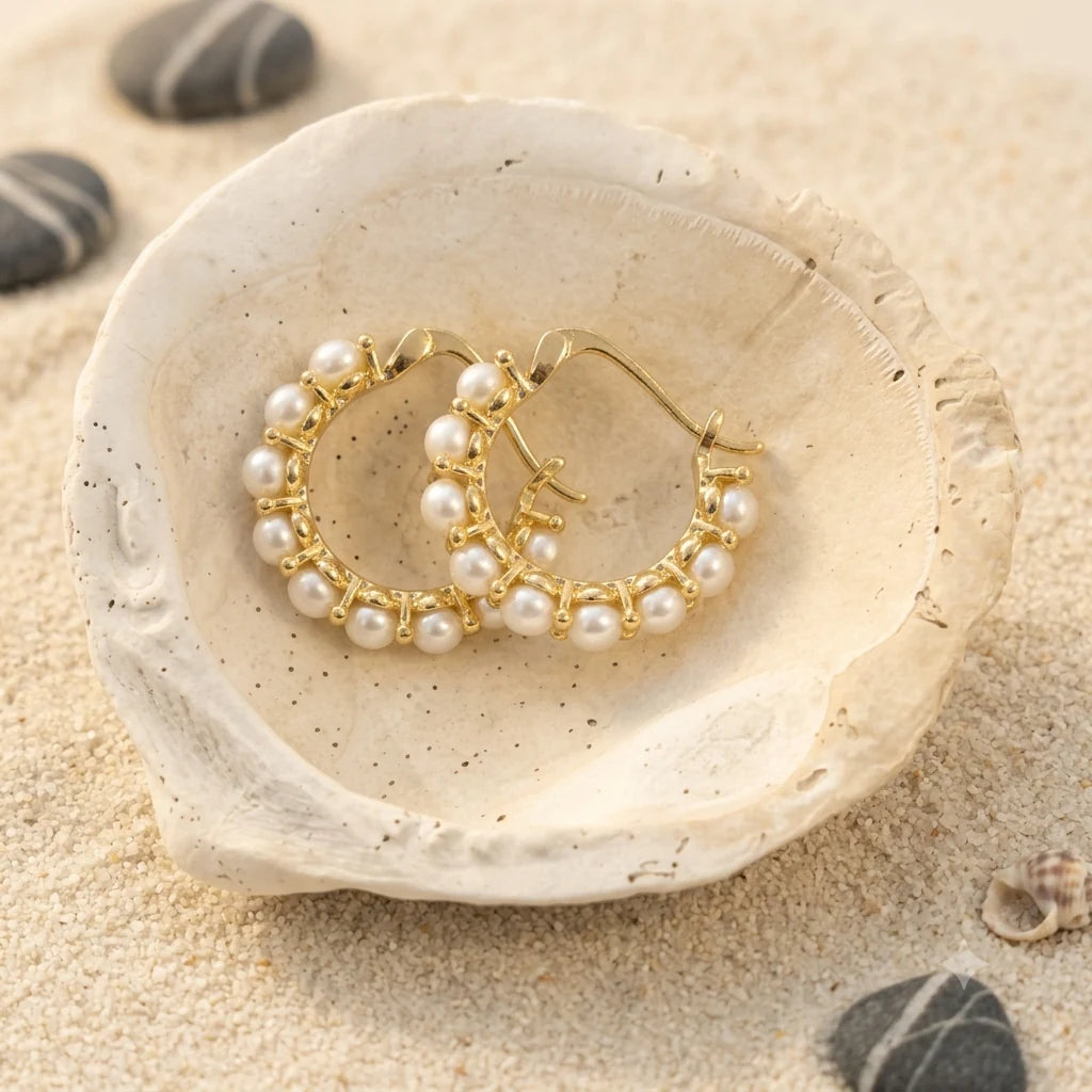 Mini Pearl Huggie Earrings in Gold-plated brass with 925 sterling silver posts displayed in a product styling scene.