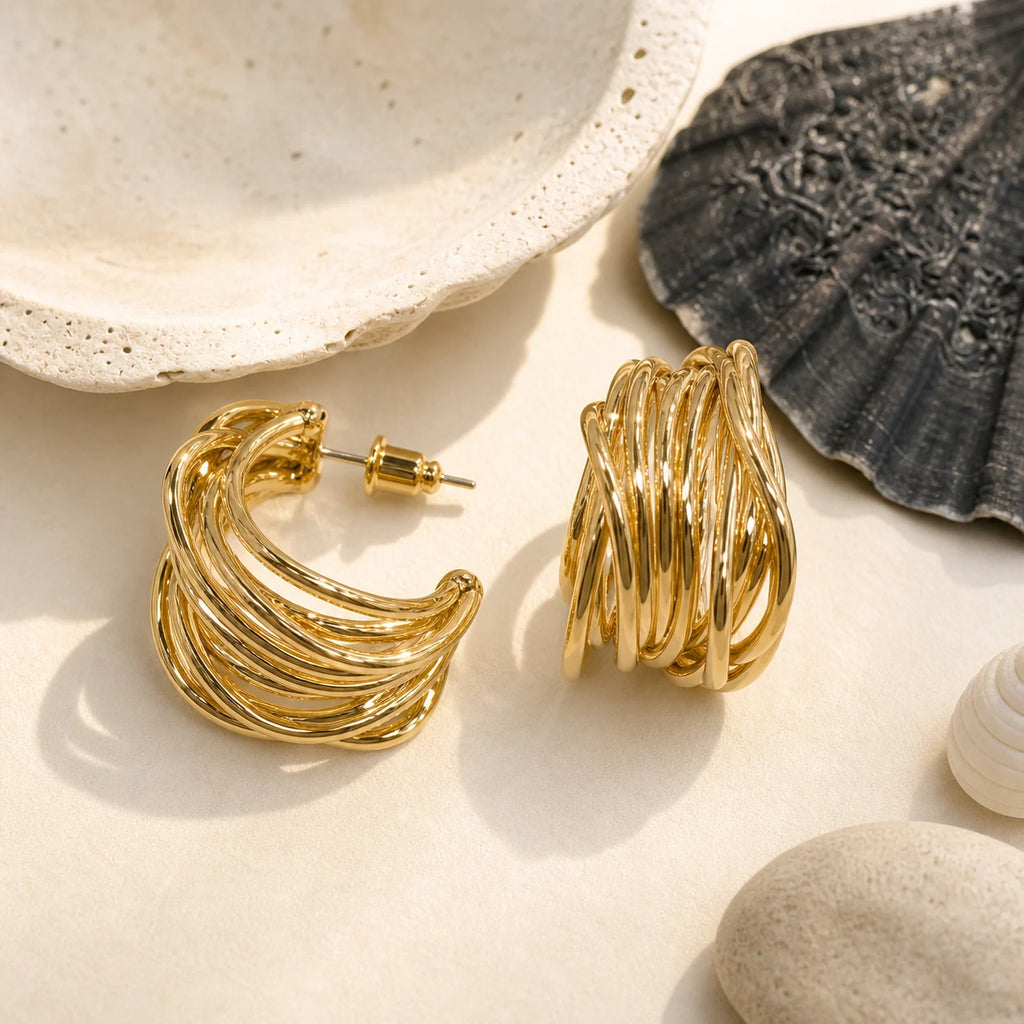 Openwork Ear Cuff in Gold-plated brass with 925 sterling silver hooks displayed in a product styling scene.