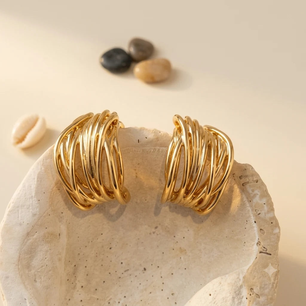Close-up of openwork ear cuff in Gold-plated brass with 925 sterling silver hooks.