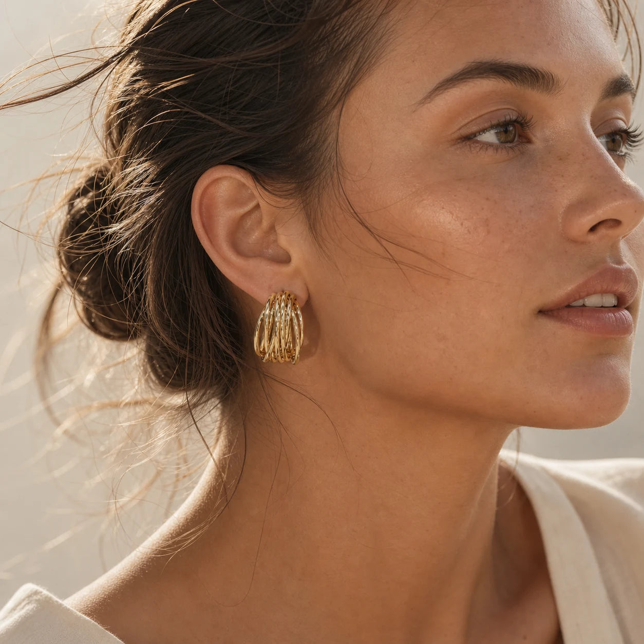 Close-up of openwork ear cuff in Gold-plated brass with 925 sterling silver hooks.