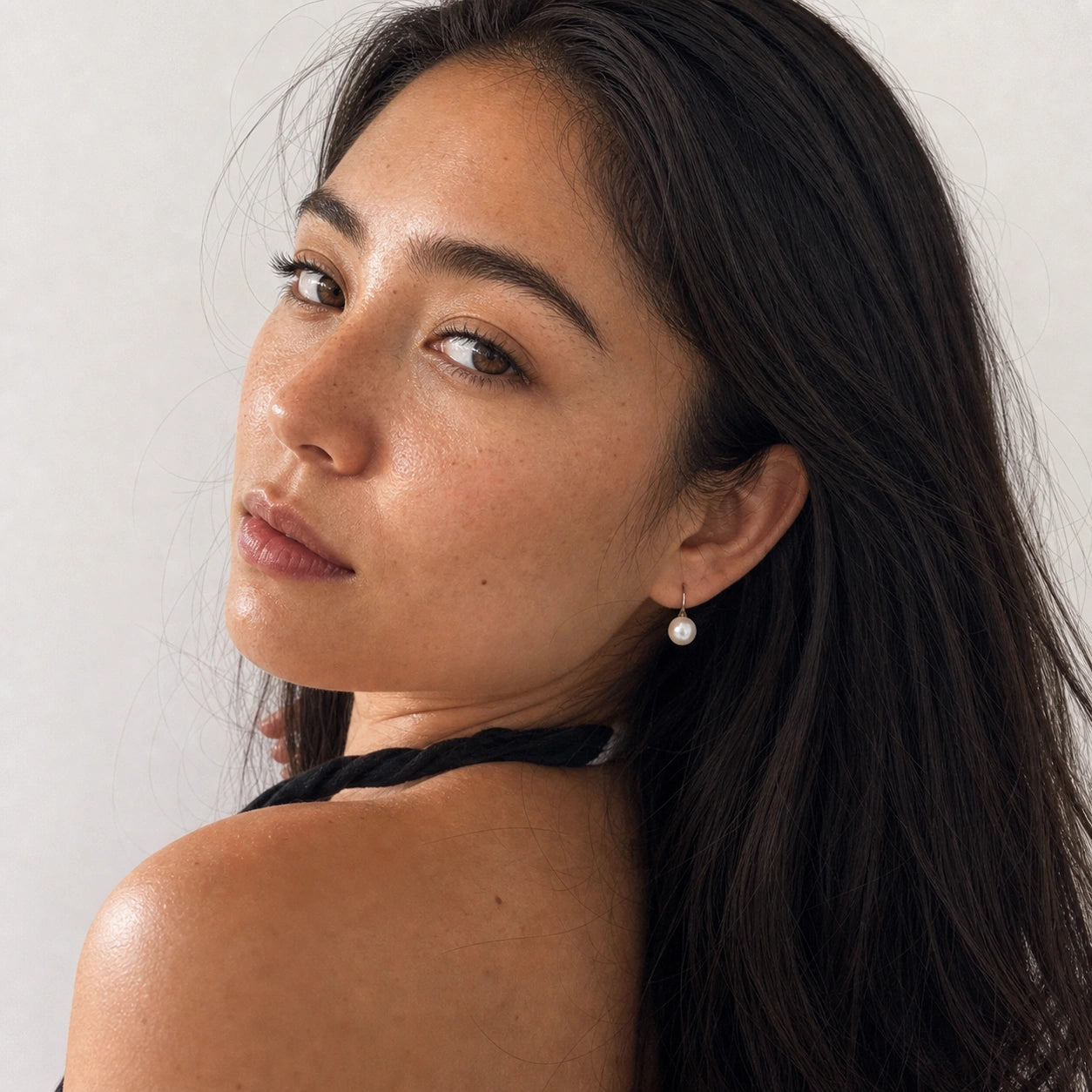 Freshwater pearl hook earrings in silver model wearing close-up