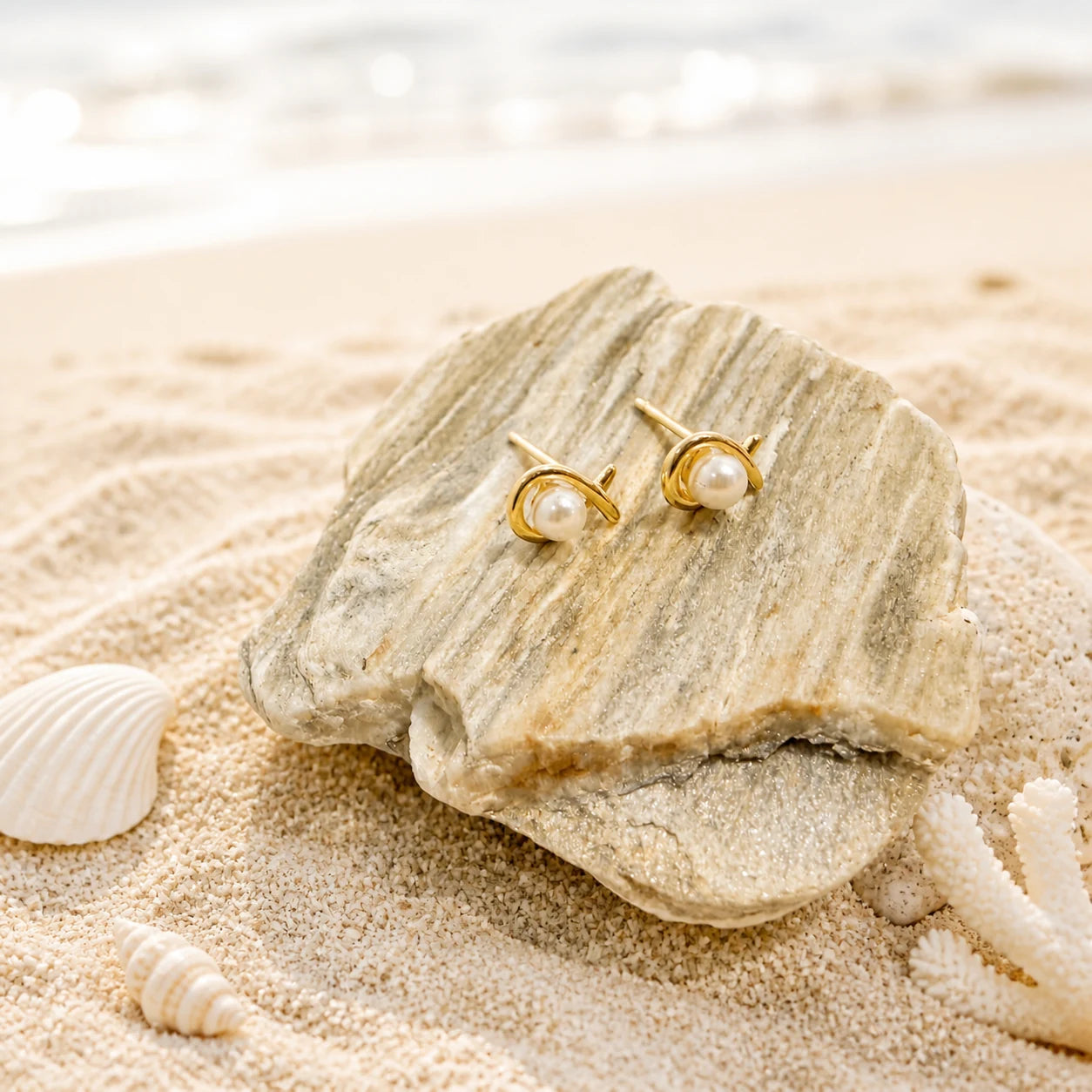 Close-up of pearl circle stud earrings in Gold-plated brass with 925 sterling silver posts.