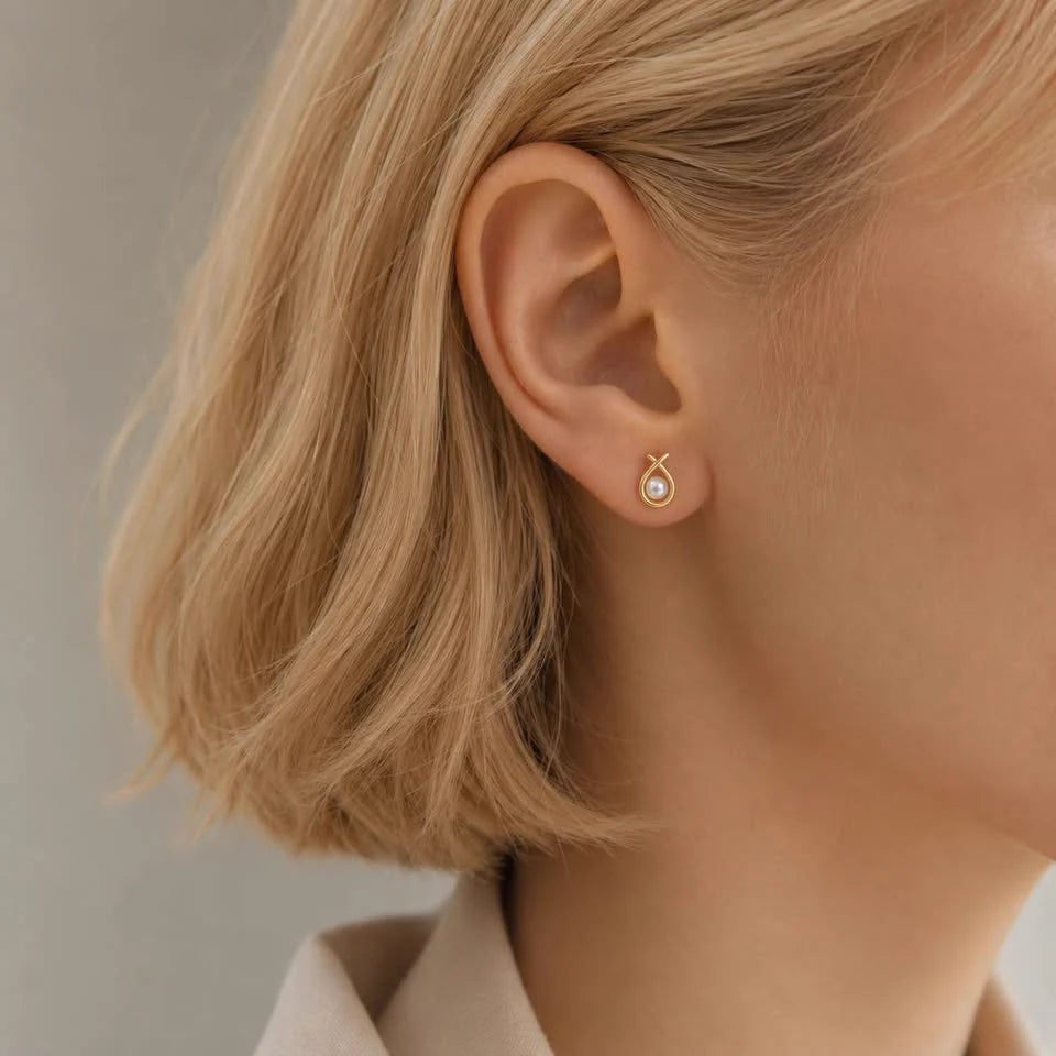 Close-up of pearl circle stud earrings in Gold-plated brass with 925 sterling silver posts.