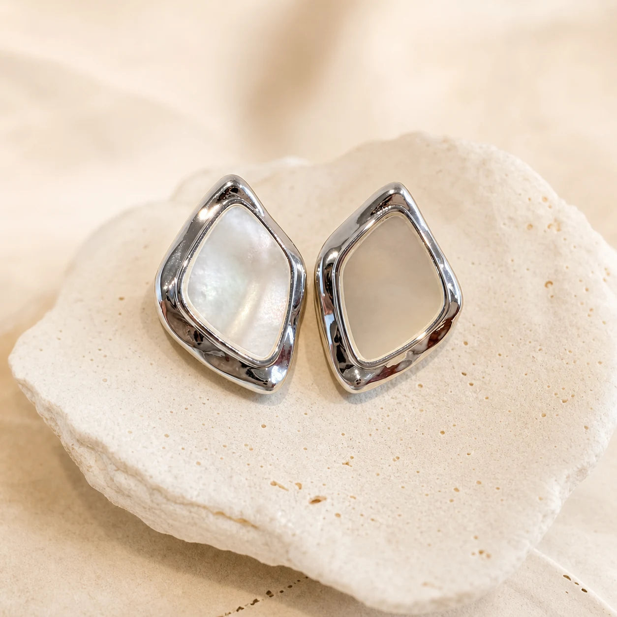 Square Mother-of-Pearl Earrings in Rhodium-plated brass with 925 sterling silver posts displayed in a product styling scene.