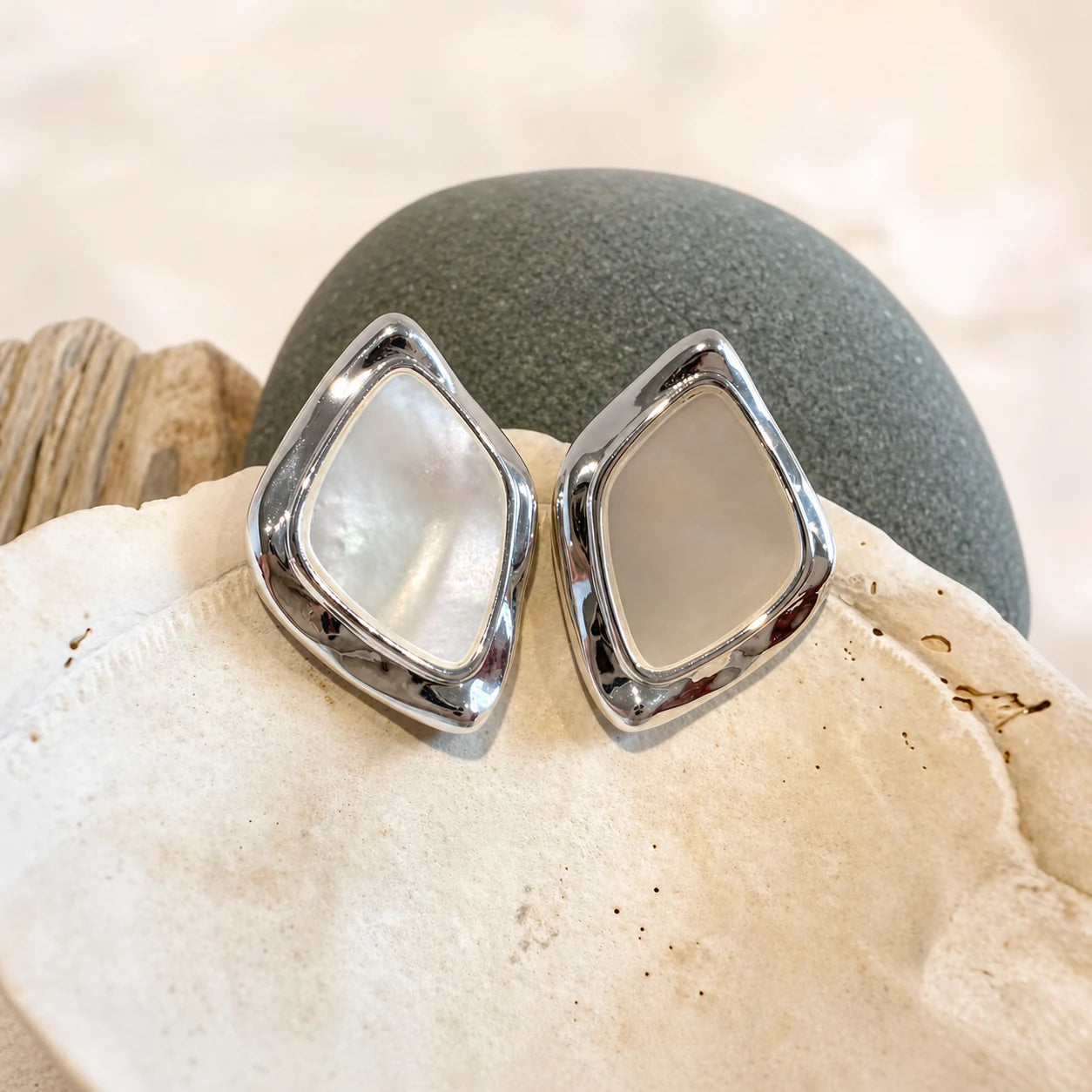 Close-up of square mother-of-pearl earrings in Rhodium-plated brass with 925 sterling silver posts.