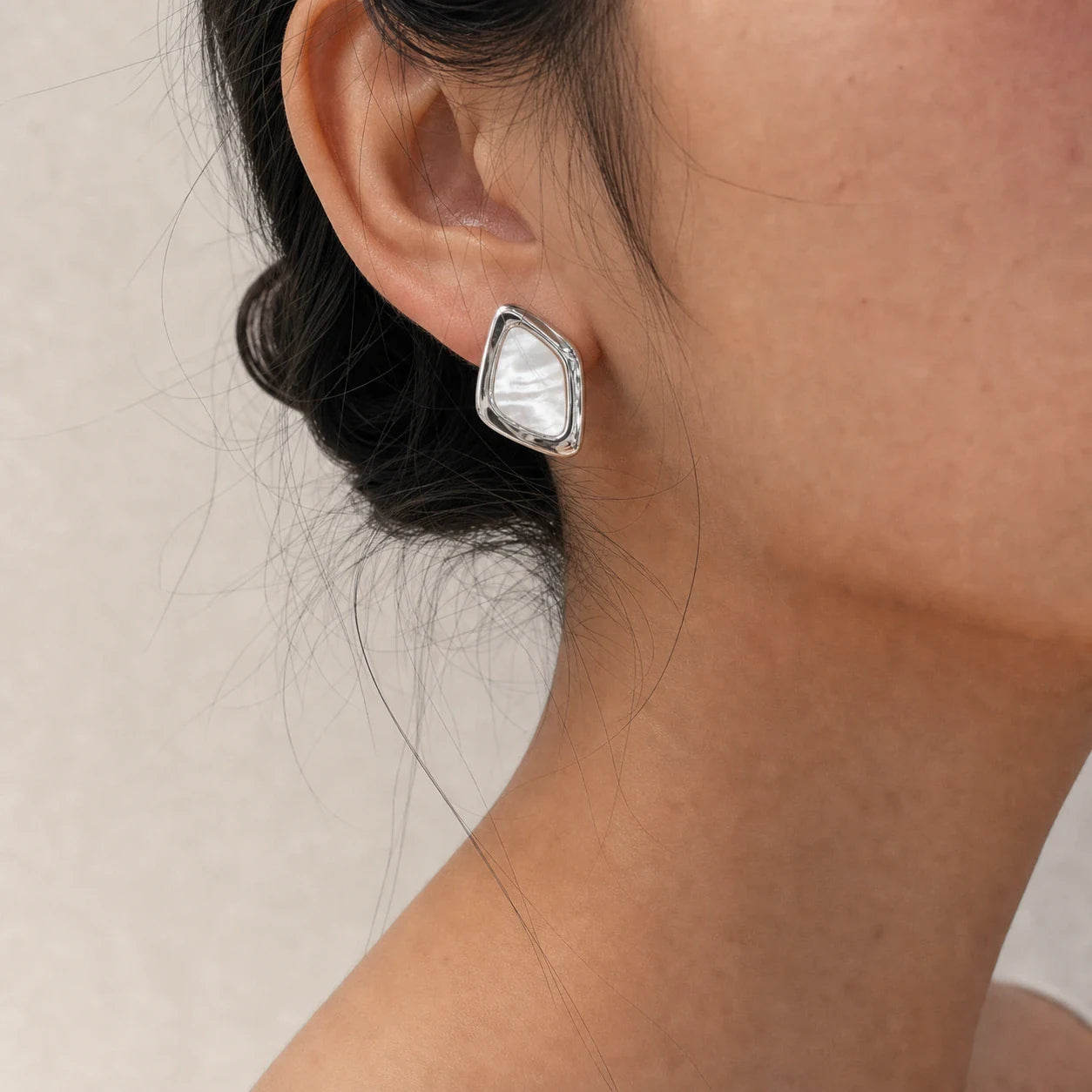 Close-up of square mother-of-pearl earrings in Rhodium-plated brass with 925 sterling silver posts.