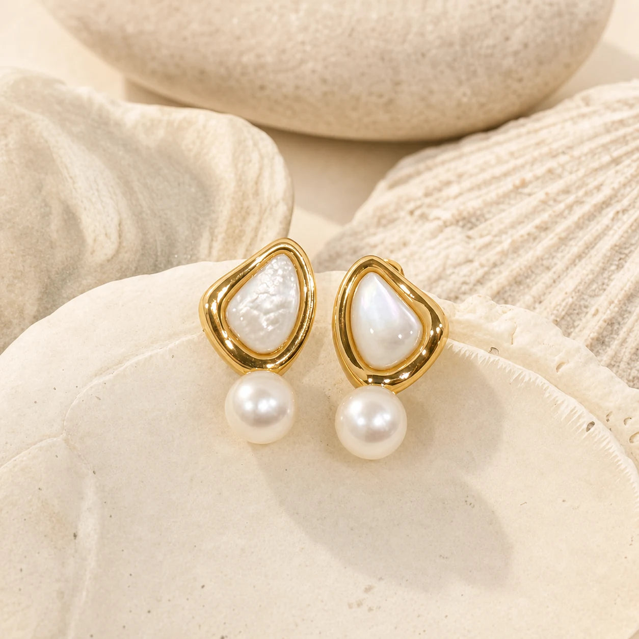 Triangle Pearl Stud Earrings in 14k gold-plated brass with 925 sterling silver posts displayed in a product styling scene.
