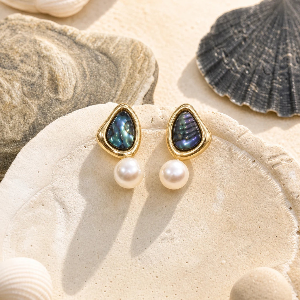 Triangle Pearl Stud Earrings in 14k gold-plated brass with 925 sterling silver posts displayed in a product styling scene.