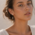Triple Pearl Tassel Earrings in Gold-plated brass with 925 sterling silver hooks displayed in a product styling scene.