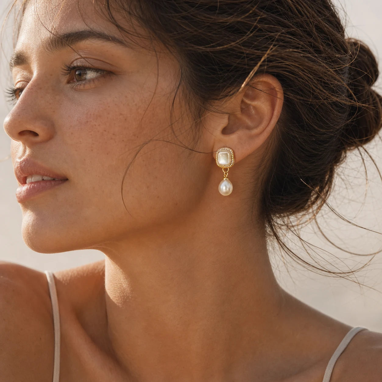 Close-up of vintage mother-of-pearl pearl drop earrings in Gold-plated brass with 925 sterling silver posts.