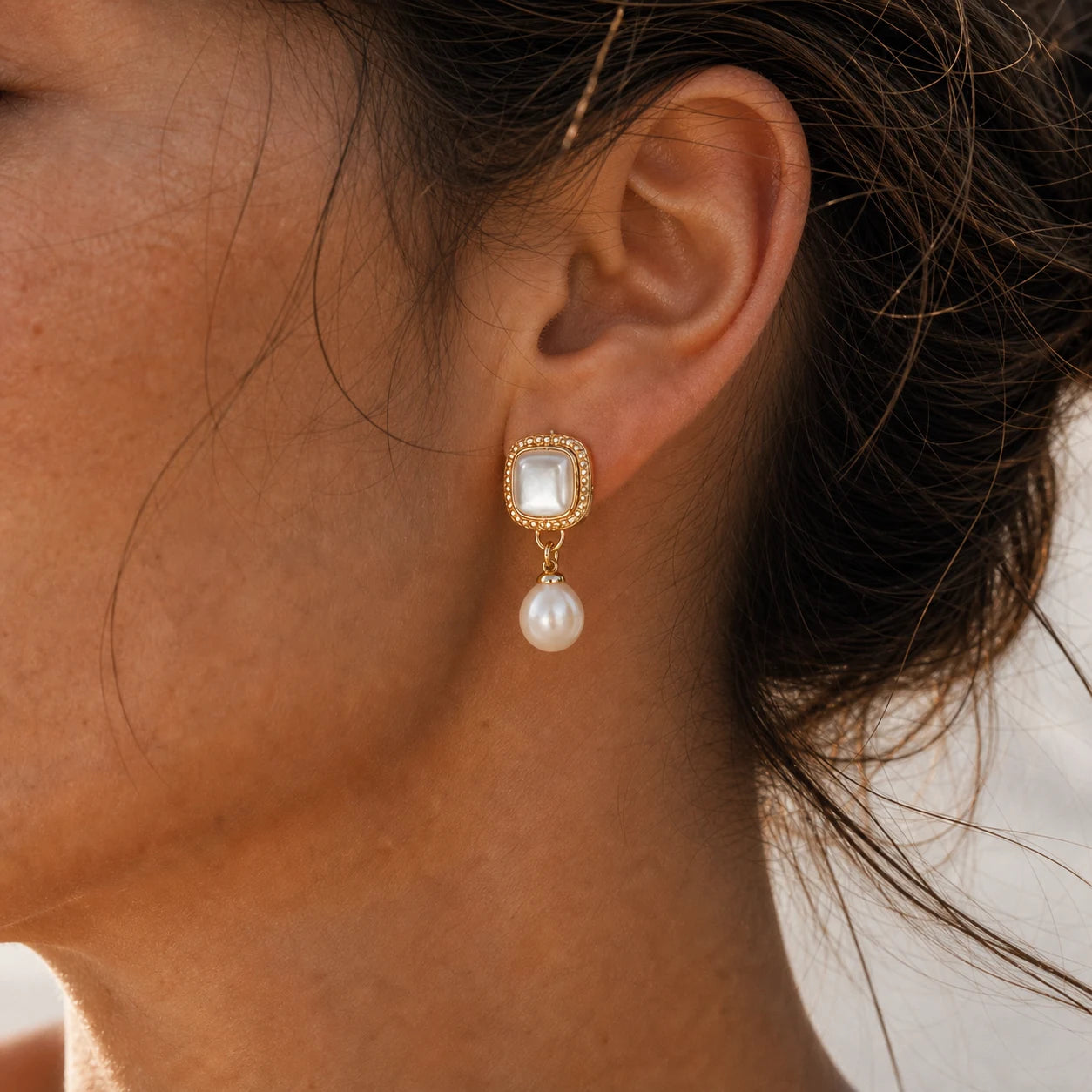 Close-up of vintage mother-of-pearl pearl drop earrings in Gold-plated brass with 925 sterling silver posts.